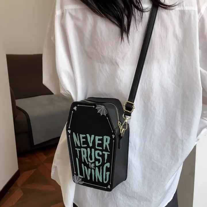 Perfect Halloween Coffin Bag • "Never Trust the Living" Design • Adjustable Strap • Zipper Closure • Polyester Lining • Dry Clean Only • Black Crossbody for Women • Halloween Costume Accessory • Trickory Desig